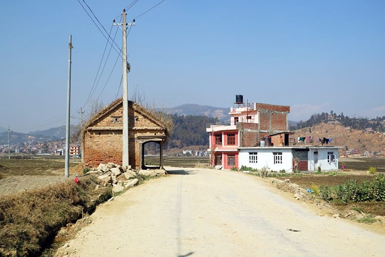 The road leading up to Panauti with a small brick rest stop for travelers