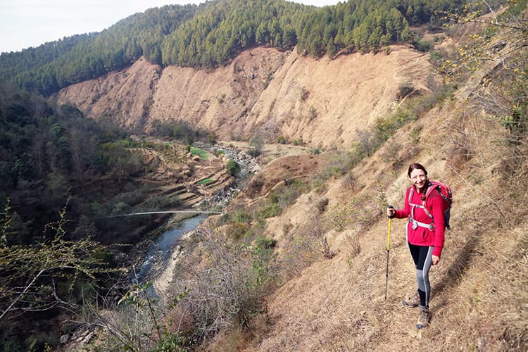 Michelle Della Giovanna from Full Time Explorer walks down a steep path on the way down a river valley