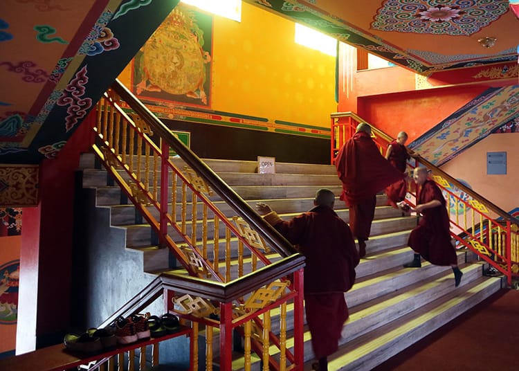 Novice monks run to the temple to chant at Namo Buddha Monastery in Nepal