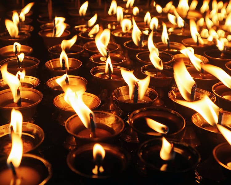 Candles flicker outside of Boudhanath Stupa during the Losar Festival in Nepal