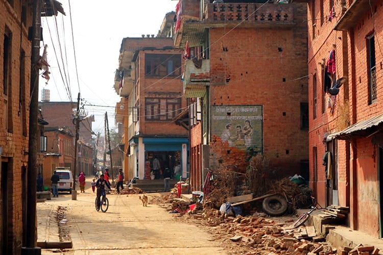 A child rides his bike down the streets of Panauti in Nepal