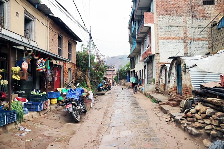 A small street in Nepal with a vegetable shop