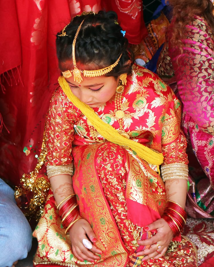 A Newari girl sits and waits during the Ihi ceremony