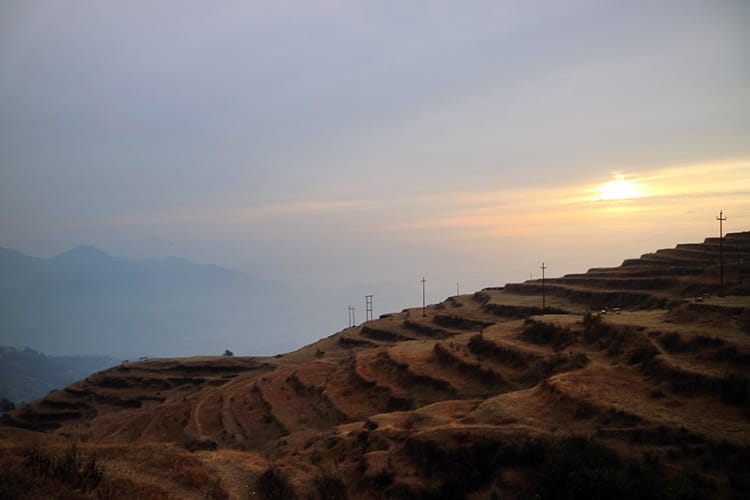 Golden terrace style farms in Kakani Nepal at sunset