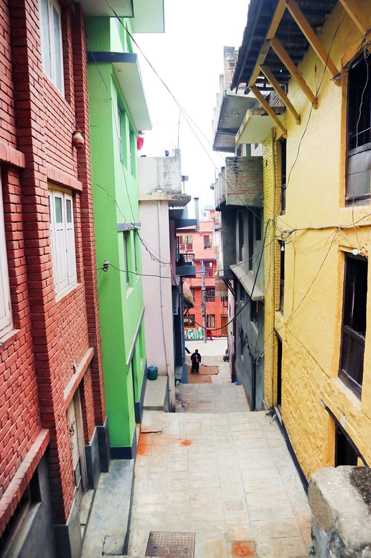 Colorful houses line the steep alleyway in Kirtipur Nepal