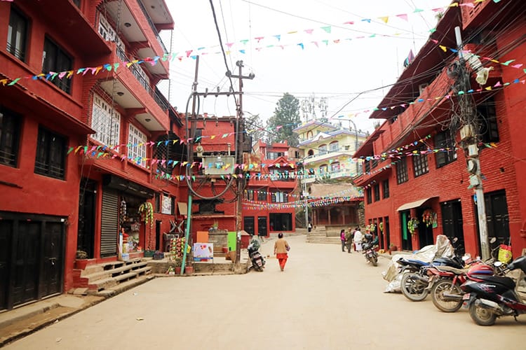 A street in Kirtipur with red brick buildings on either side