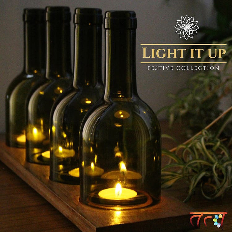 A candle holder made from recycled wine bottles