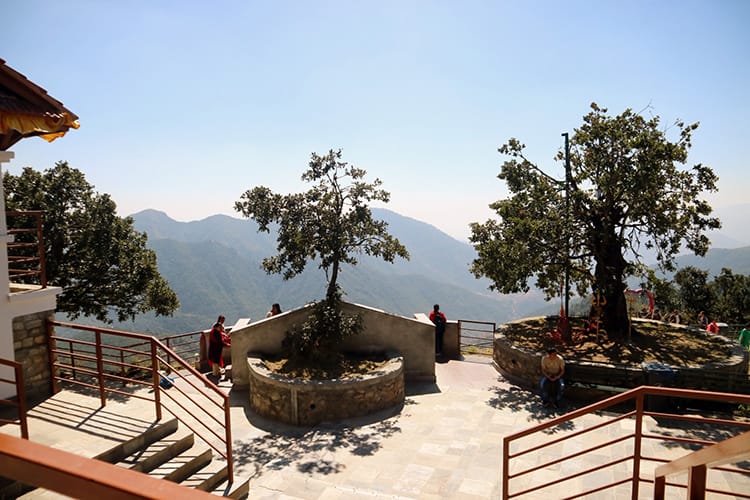 People sit and admire the view from Chandragiri Hills