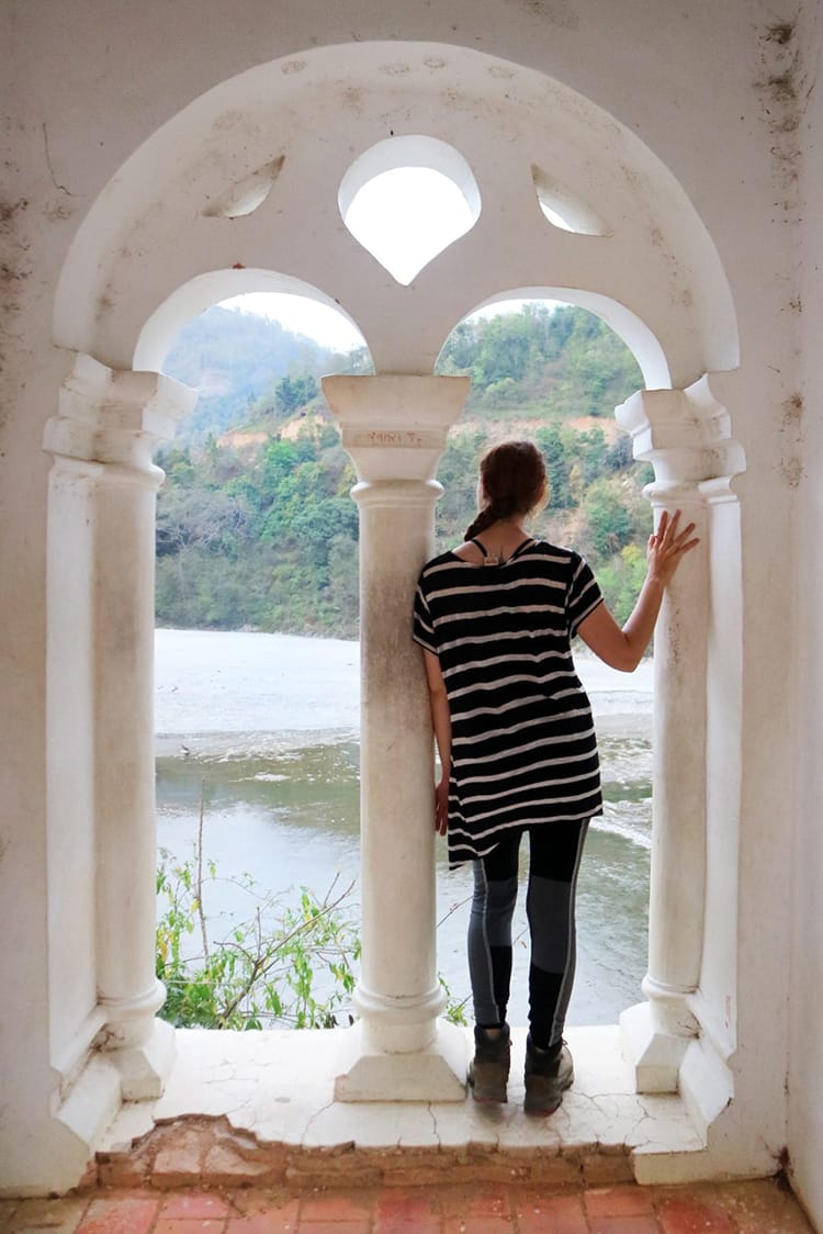 Michelle Della Giovanna from Full Time Explorer stands in an archway at the Rani Mahal in Palpa, Nepal