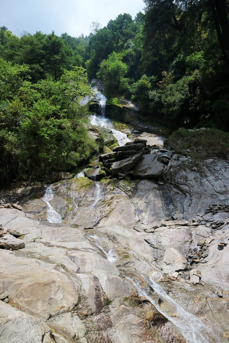 Waterfall cascading into the river on the way to Dongang Village in Nepal