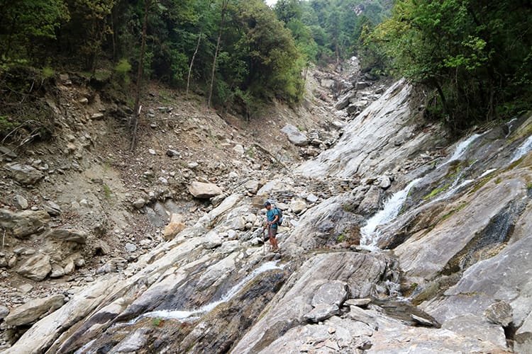 A man crosses a landslide area in Gaurishankar Conservation Area in Nepal
