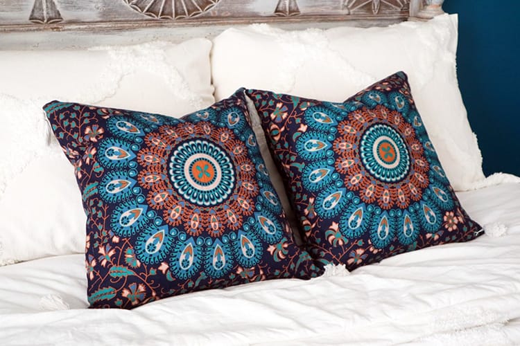 Two blue accent pillows with a mandala print
