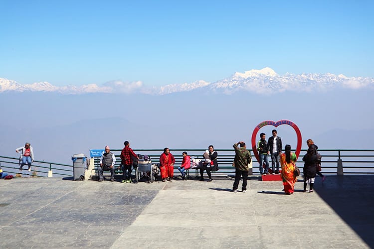 People take pictures in front of the incredible view of the Himalaya mountains from the top of Chandragiri Cable Car