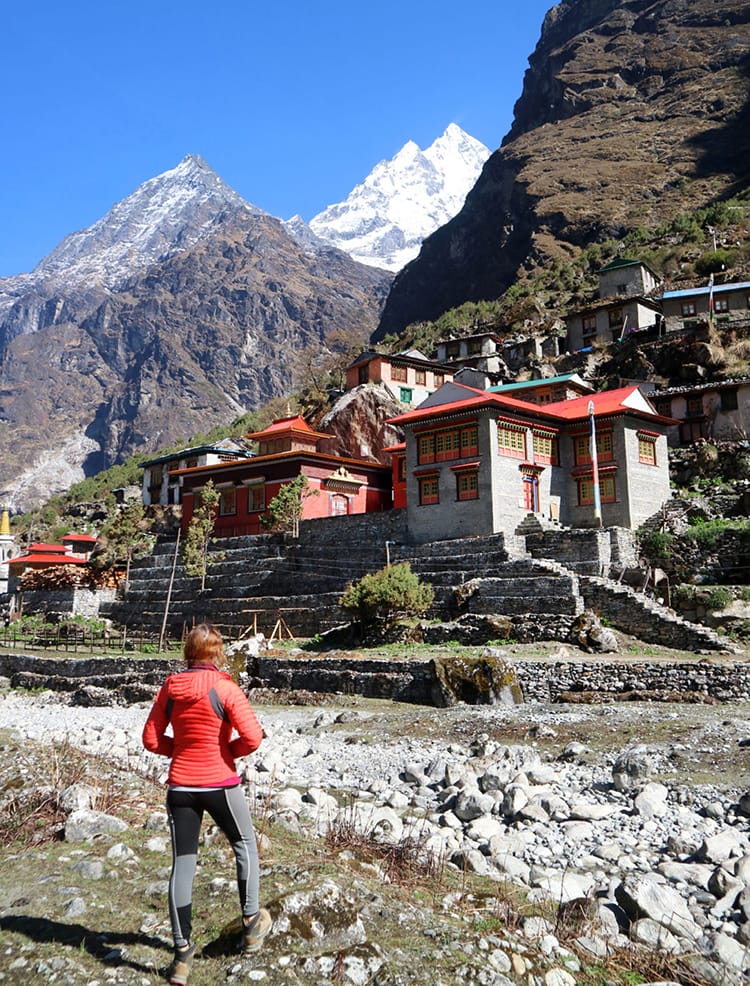 Michelle Della Giovanna from Full Time Explorer stands in front of the beautiful new monastery in Beding, Nepal