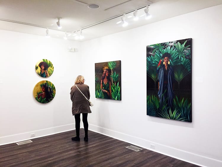 A woman admires Sara Golish's painting at the Franklin G Burroughs Art Museum in Myrtle Beach