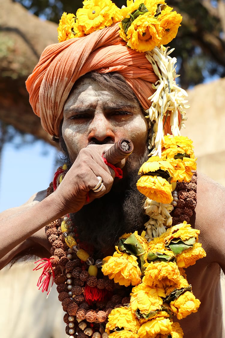 An eclectic guru in Pashupathinath Temple during Maha Shivaratri in Nepal smoking a large joint
