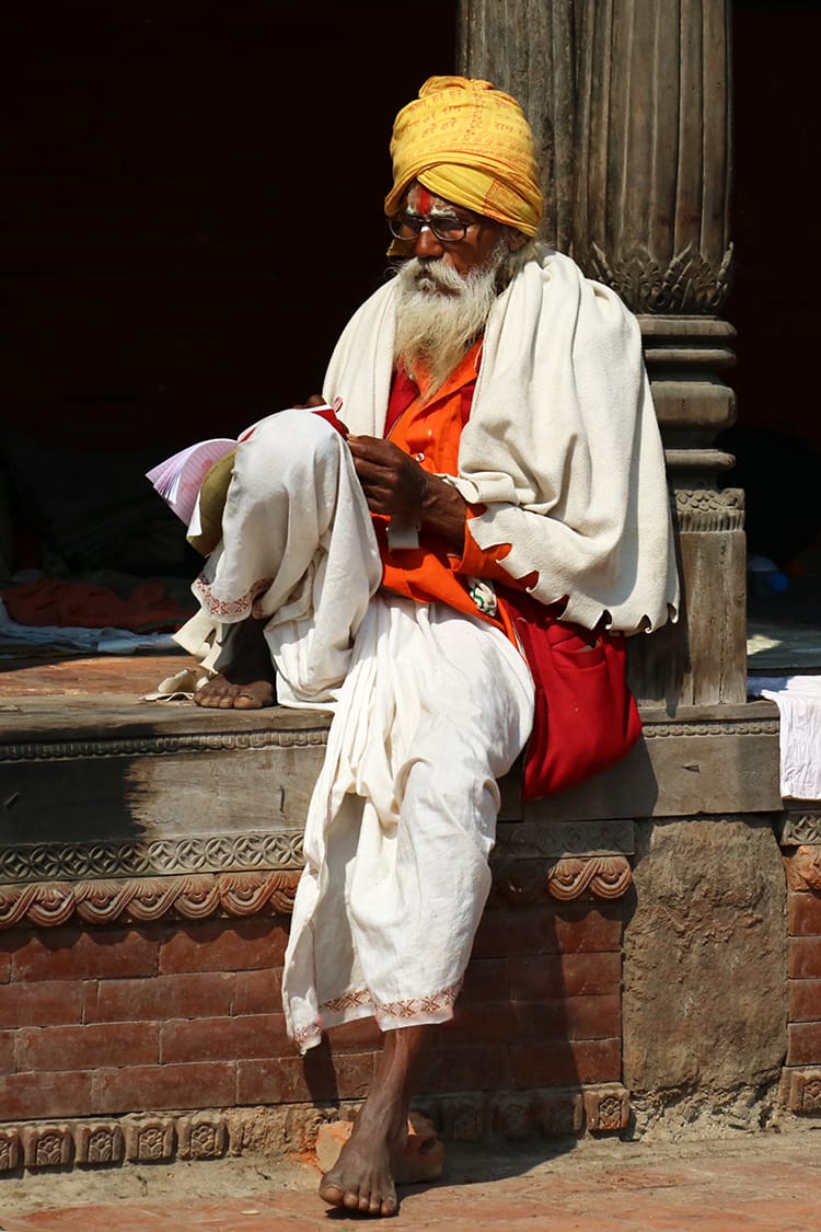 Guru reading in Pashupathinath Temple during Maha Shivaratri in Nepal