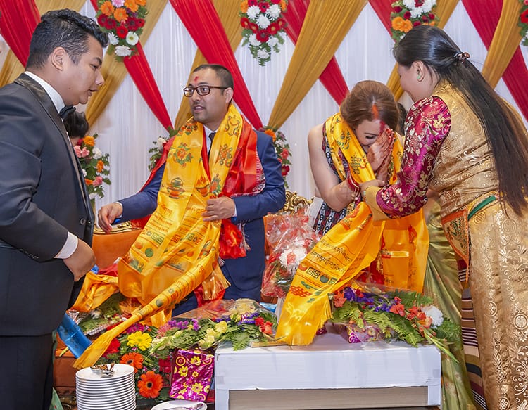 Michelle Della Giovanna from Full Time Explorer and Suraj Pradhan are given hundreds of Khata from their friends and family in the reception line