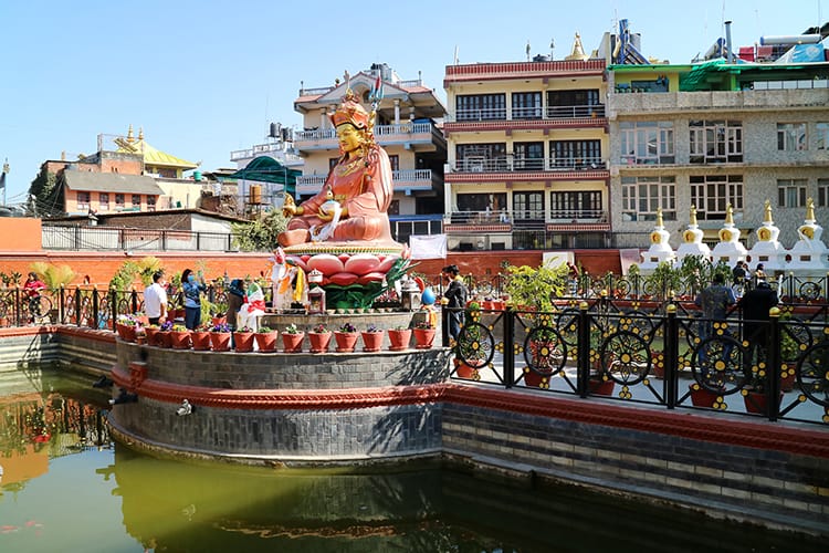 A large statue sits in a pond just behind Boudhanath Stupa in the Peace Park
