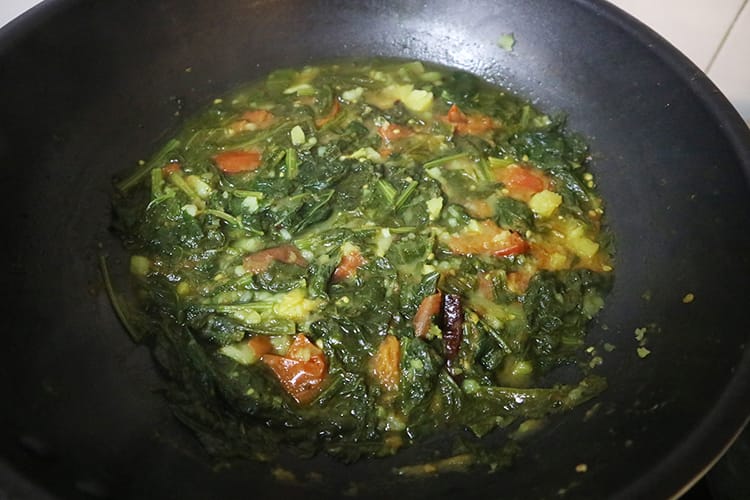 Aloo Saag in the pan while simmering a few minutes before being complete