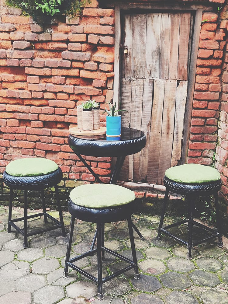 A bistro table and stools made by Tyre Treasures in Nepal