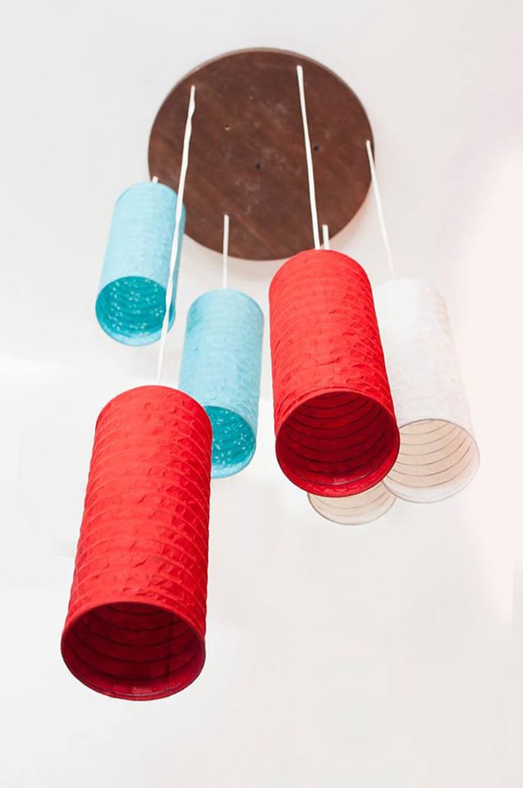 A blue red and white paper lantern made by Jamarko in Nepal