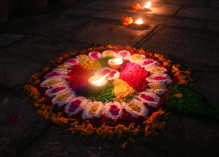 A simple rangoli mandala lays in front of a home on Laxmi Puja