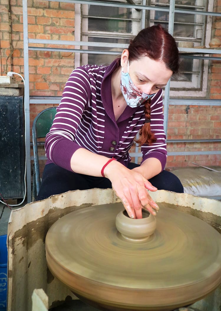 Michelle Della Giovanna from Full Time Explorer trying to make an ash tray on the pottery wheel