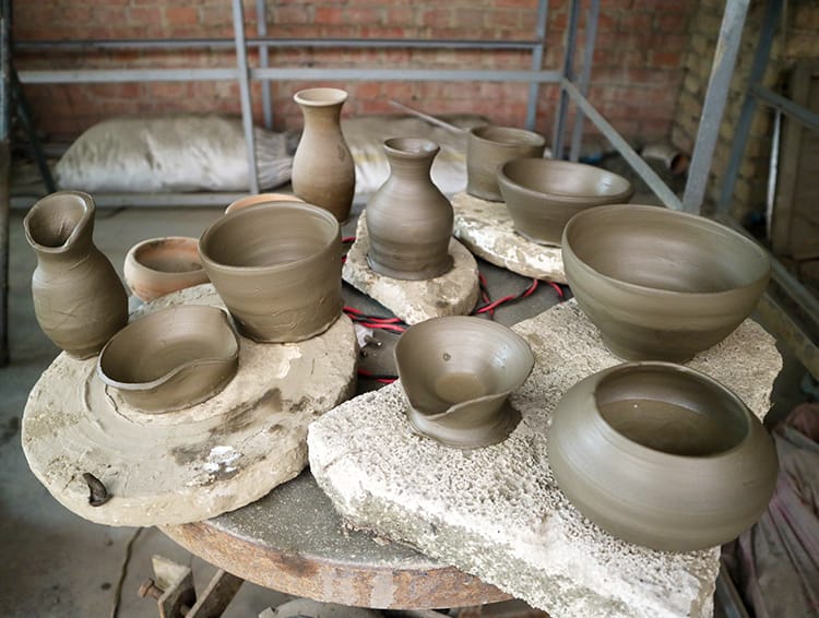 Several pieces of pottery made during our pottery class in Kathmandu sitting and drying before being kilned