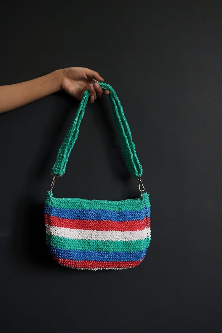A colorful purse made from upcycled fabrics made by Samsara Creation