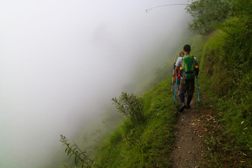 Trekkers walk from Khopra Danda to Paudwar Village in a dense fog
