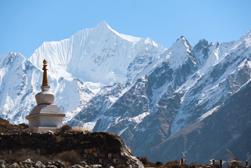 A buddhist stupa in front of the Langtang mountain range