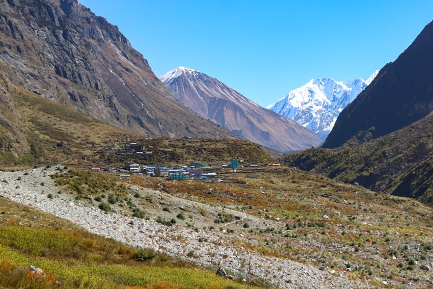 A view of Langtang village from a distance with the Himalaya in the background