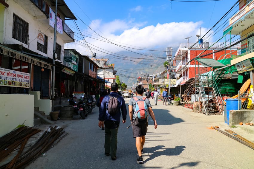 Trekkers walk through Syabrubesi on the way back from Langtang