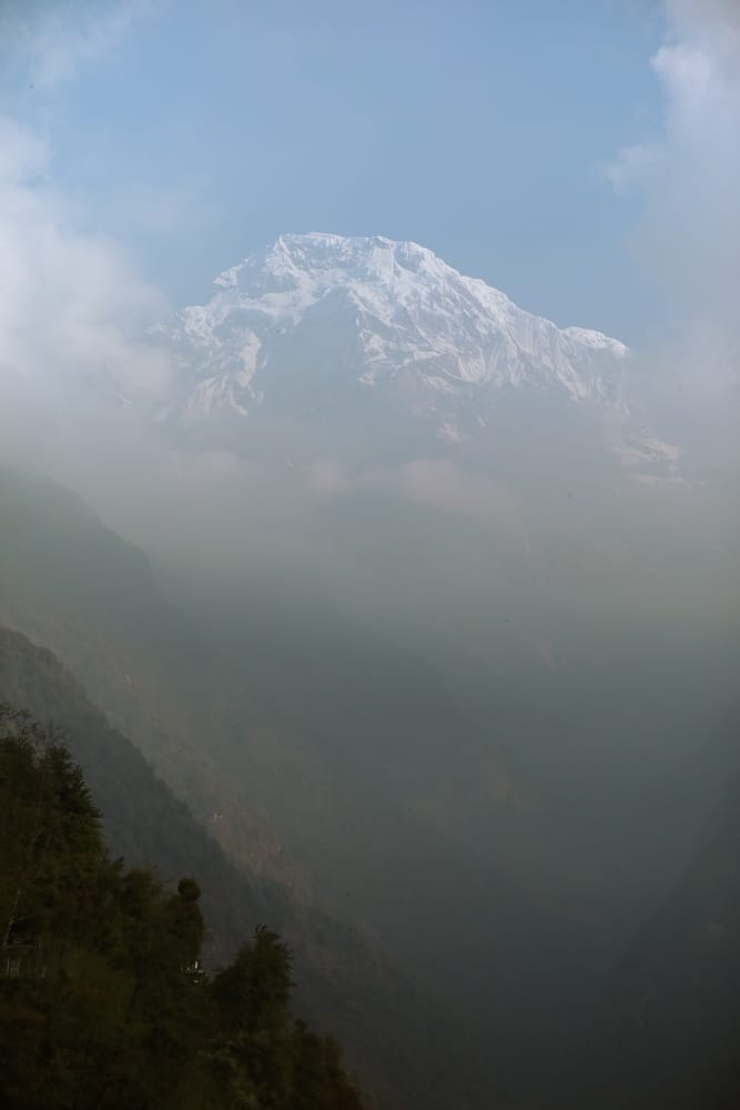 View of the Himalaya mountains above the clouds from Chomrong, Nepal