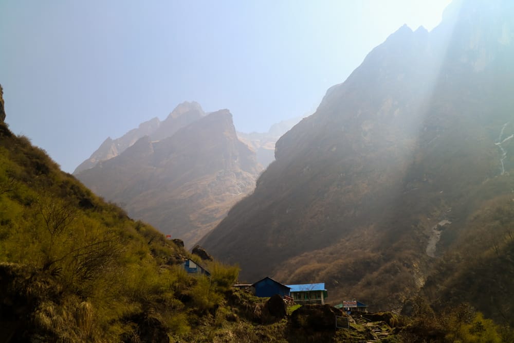 The village of Deurali from above with light pouring through the mountains