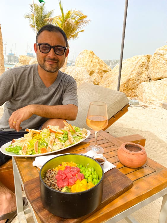 Eating a salad and poke bowl at the beach in Dubai