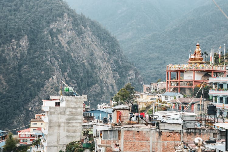 Buildings in Dhunche village with a Guru Rinpoche Statue on top