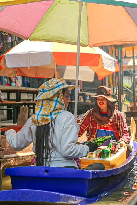 People sell beer and drinks out of a boat at Damnoen Saduak Floating Market - Best Things to do in Bangkok