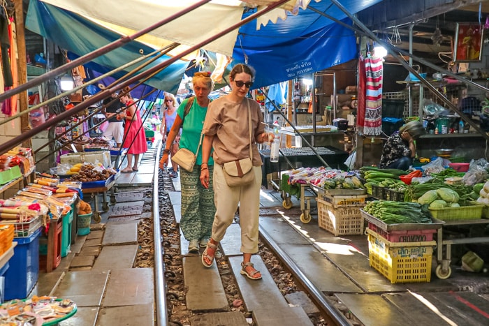 Michelle and her mom walking through the Mae Klong Railway Market