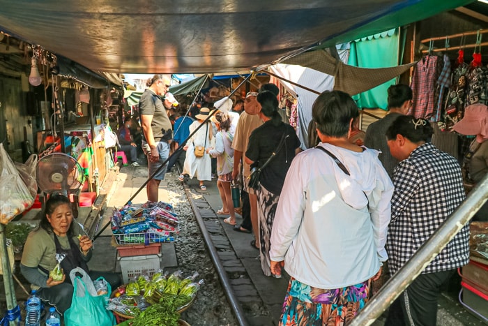 People walking through the Mae Klong Railway Market - Best Things to do in Bangkok