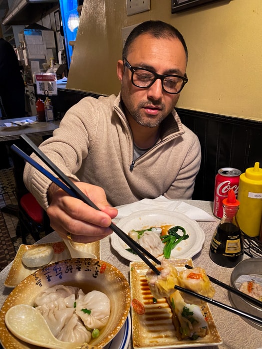 Suraj eating food in Chinatown
