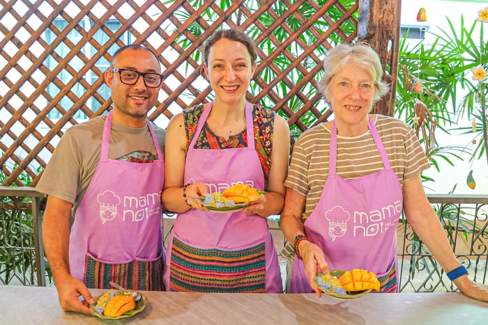 Michelle Della Giovanna, her husband and her mom showing off the food they made made in a cooking class in Chiang Mai