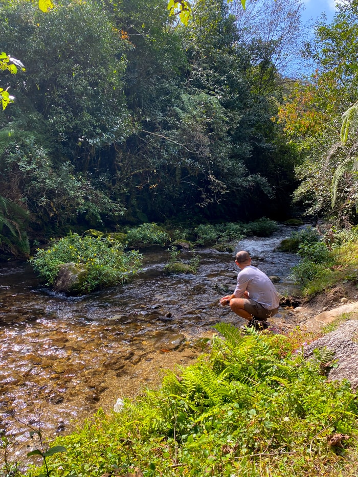 Suraj sits by the river where we had lunch