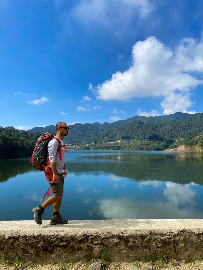 Suraj walks on a platform in front of Dhap Dam