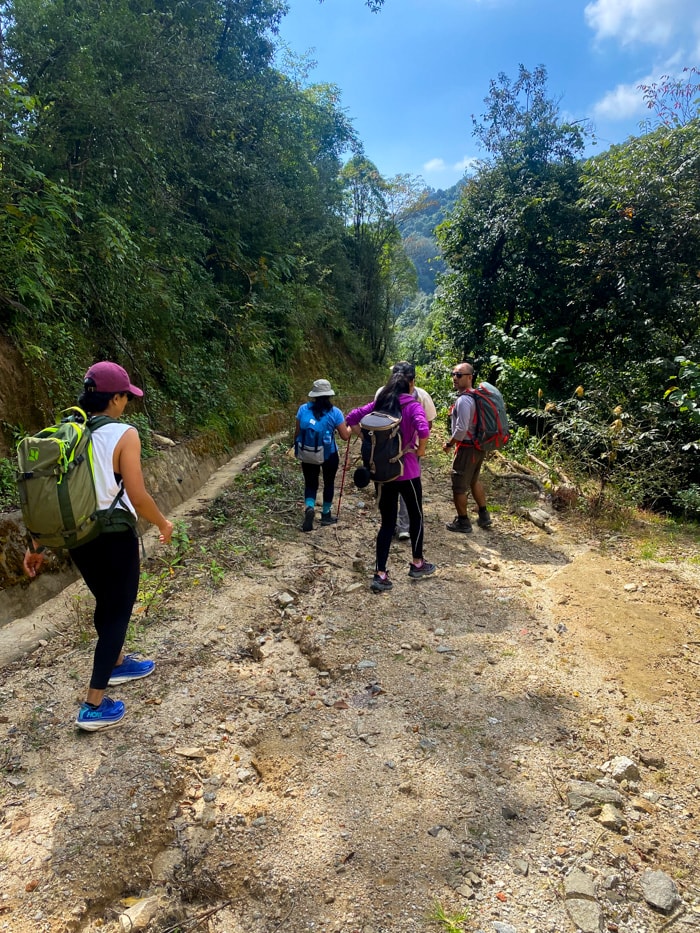 A group hiking down the small road that goes behind Dhap Dam